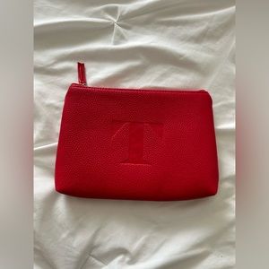 Red T monogram clutch